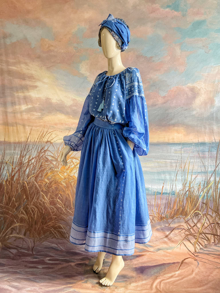 Fine soft pure cotton weave in a fresh sky blue and white palette. Full sleeved faded indigo peasant blouse and full dirndl skirt. Bohemian styles created from vintage textiles by Pavilion parade studio. 