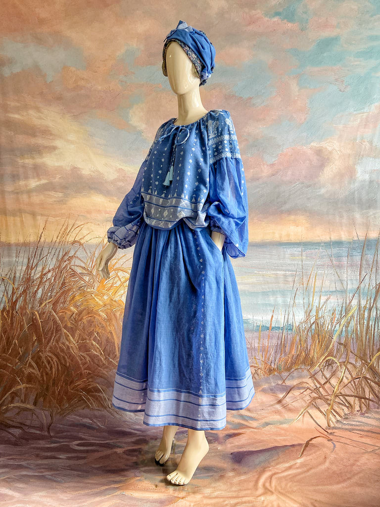 Fine soft pure cotton weave in a fresh sky blue and white palette. Full sleeved faded indigo peasant blouse and full dirndl skirt. Bohemian styles created from vintage textiles by Pavilion parade studio. 