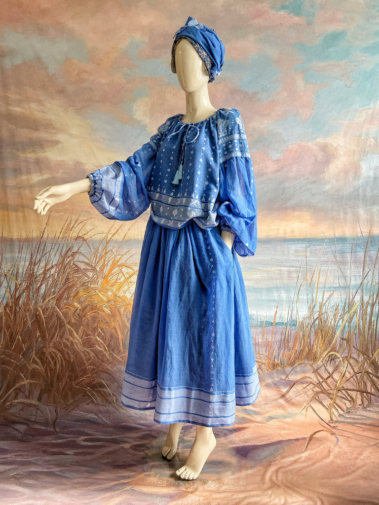 Fine soft pure cotton weave in a fresh sky blue and white palette. Full sleeved faded indigo peasant blouse and full dirndl skirt. Bohemian styles created from vintage textiles by Pavilion parade studio. 