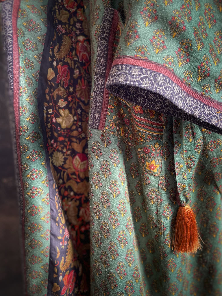 Forest green, conker brown and saffron yellow floral fine wool robe with silk lining. Wide sleeves, deep pockets and tassel sash. Unique bohemian style created from vintage and antique textiles by the Pavilion Parade studio.