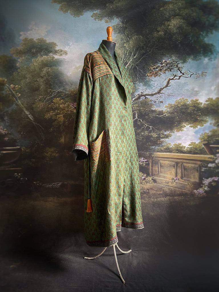 Forest green, conker brown and saffron yellow floral fine wool robe with silk lining. Wide sleeves, deep pockets and tassel sash. Unique bohemian style created from vintage and antique textiles by the Pavilion Parade studio.
