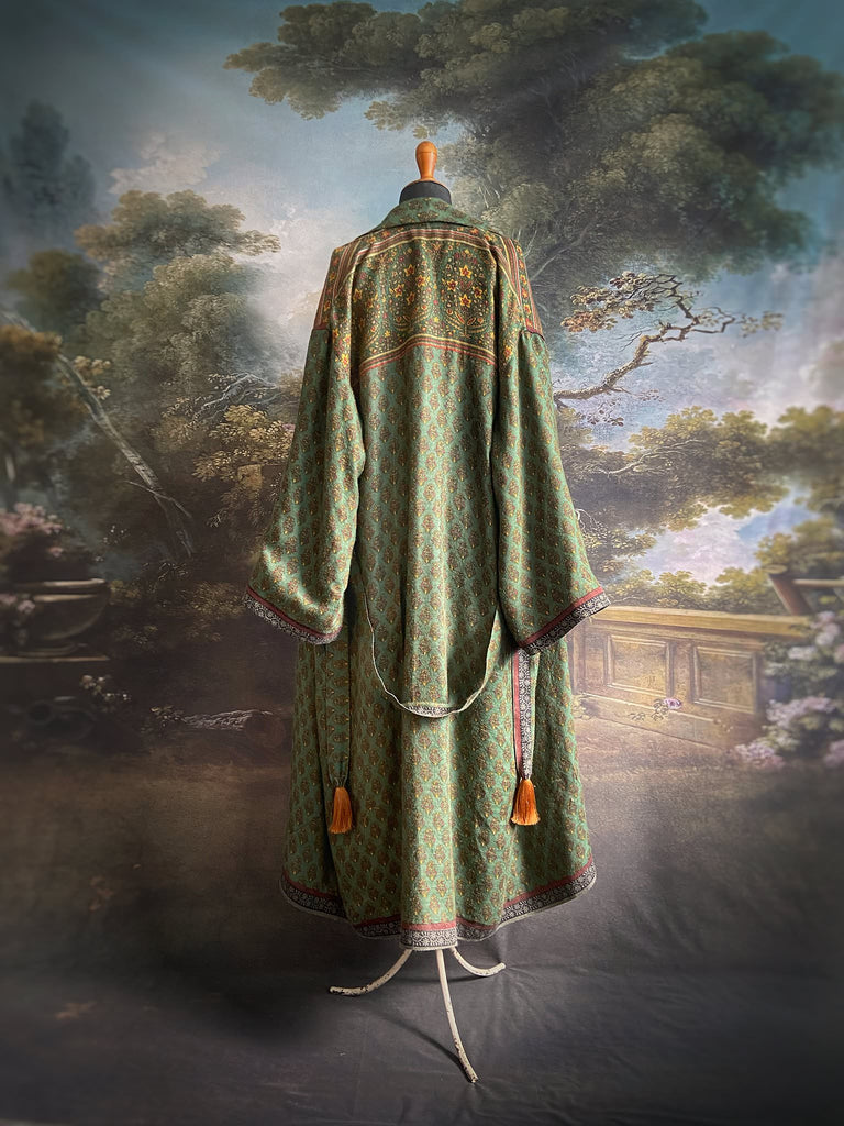 Forest green, conker brown and saffron yellow floral fine wool robe with silk lining. Wide sleeves, deep pockets and tassel sash. Unique bohemian style created from vintage and antique textiles by the Pavilion Parade studio.