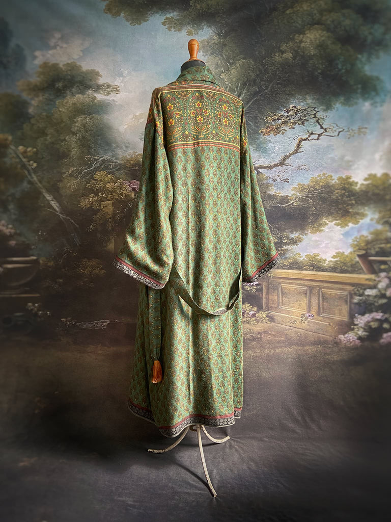 Forest green, conker brown and saffron yellow floral fine wool robe with silk lining. Wide sleeves, deep pockets and tassel sash. Unique bohemian style created from vintage and antique textiles by the Pavilion Parade studio.