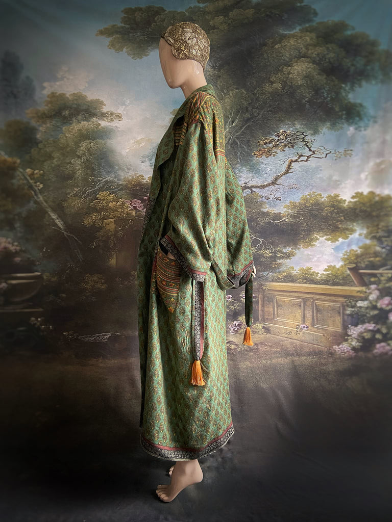 Forest green, conker brown and saffron yellow floral fine wool robe with silk lining. Wide sleeves, deep pockets and tassel sash. Unique bohemian style created from vintage and antique textiles by the Pavilion Parade studio.