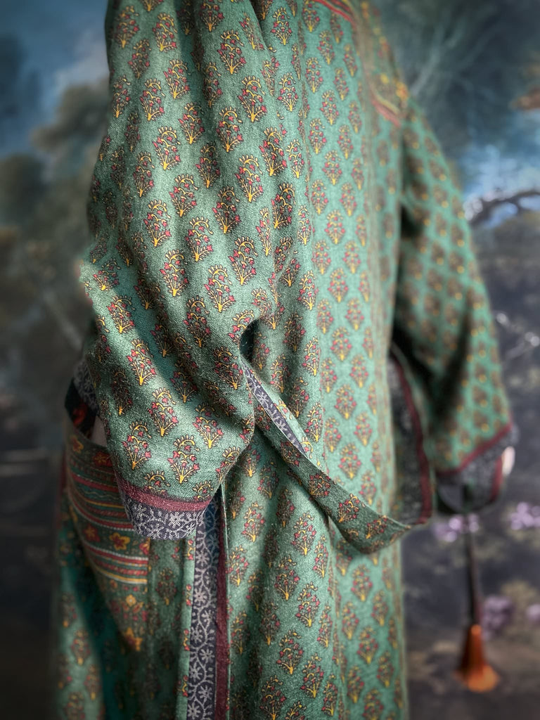 Forest green, conker brown and saffron yellow floral fine wool robe with silk lining. Wide sleeves, deep pockets and tassel sash. Unique bohemian style created from vintage and antique textiles by the Pavilion Parade studio.