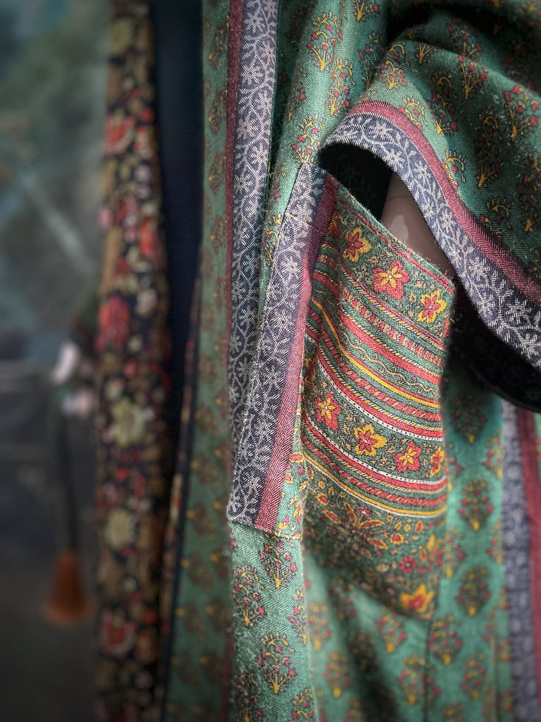 Forest green, conker brown and saffron yellow floral fine wool robe with silk lining. Wide sleeves, deep pockets and tassel sash. Unique bohemian style created from vintage and antique textiles by the Pavilion Parade studio.