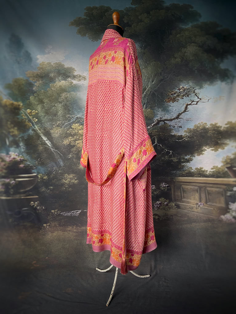 Fuchsia and saffron on a rose pink fine wool  dressing robe opr duster with wide sleeves, patch pockets and tassel sash. Bohemian style created from antique and vintage textiles by the Pavilion Parade Studio