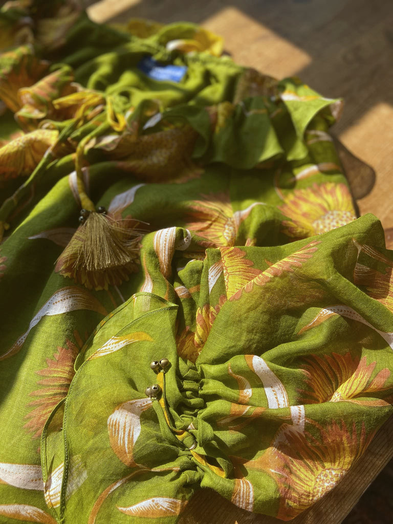 Acid green and sunflower yellow cotton muslin block printed blouse with long full sleeves and adjustable drawstring neckline. Bohemian styles sustainably created from antique and vintage textiles by the Pavilion Parade studio. 
