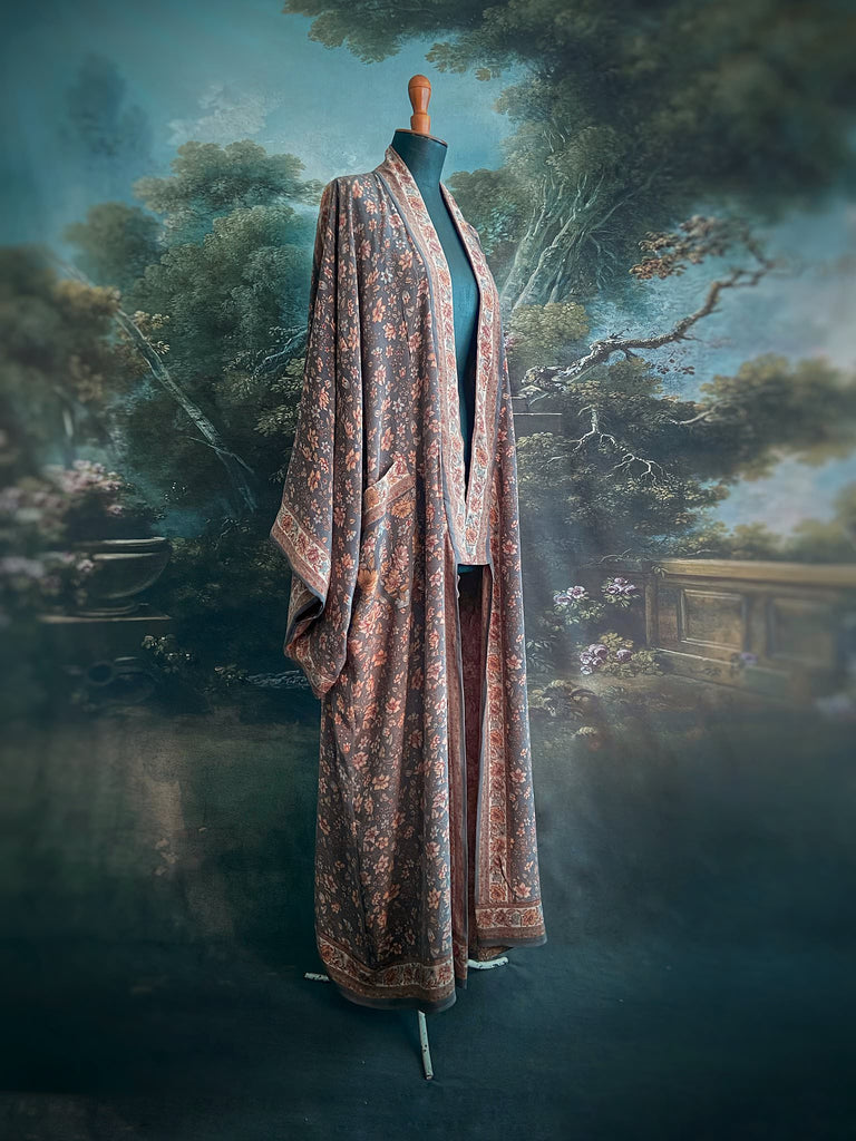 Full length 1920s inspired kimono robe with large patch pockets. Newly created from a grey, peach and apricot vintage silk crepe. Fully lined in silk with French seams throughout. Bohemian styles sustainably created from antique and vintage textiles by the Pavilion Parade studio.
