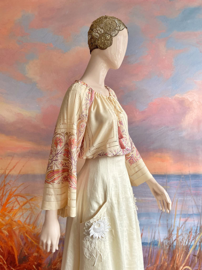 Hand embroidered cream silk blouse with coral and lavender Indian scrolling floral motifs and drawn thread work. A unique piece created from antique textiles by Pavilion Parade