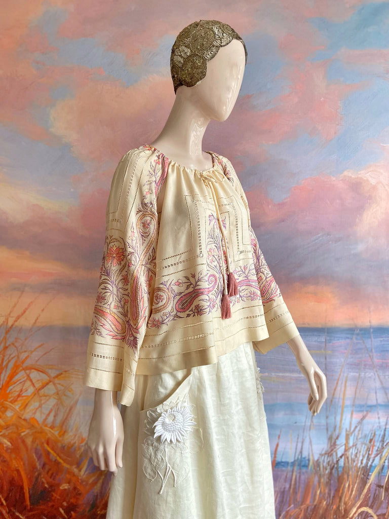 Hand embroidered cream silk blouse with coral and lavender Indian scrolling floral motifs and drawn thread work. A unique piece created from antique textiles by Pavilion Parade