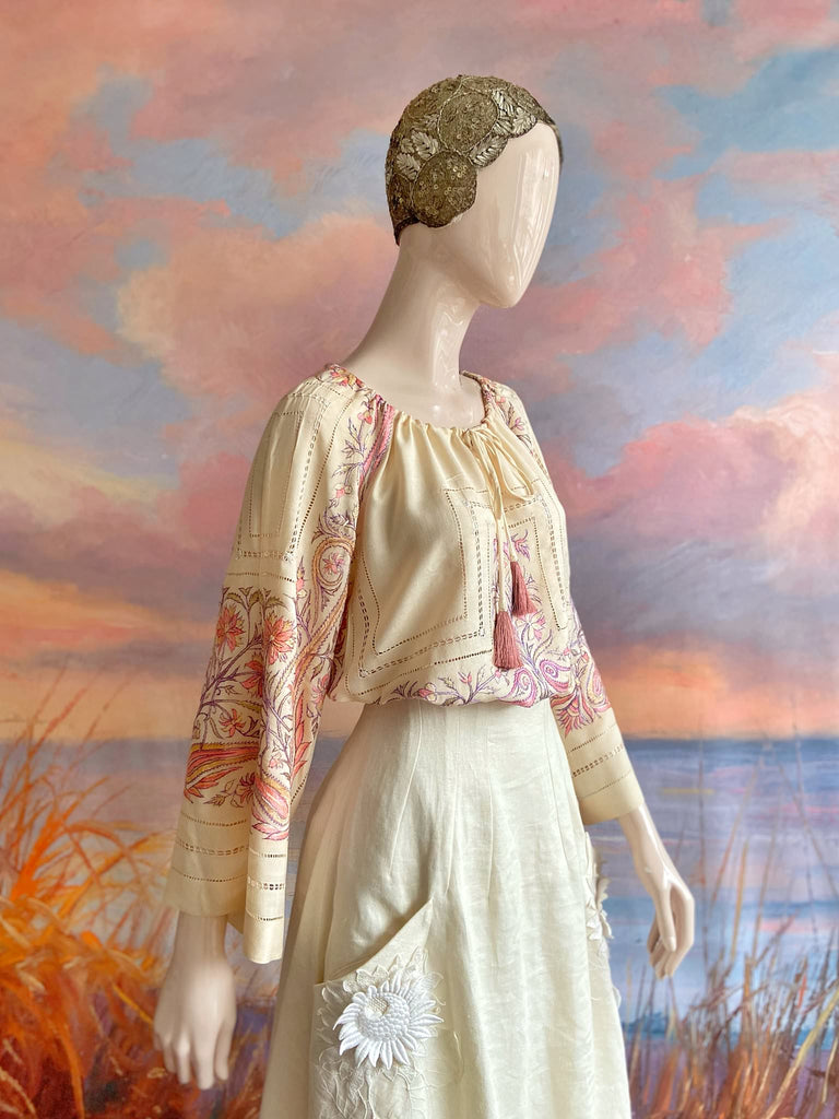 Hand embroidered cream silk blouse with coral and lavender Indian scrolling floral motifs and drawn thread work. A unique piece created from antique textiles by Pavilion Parade