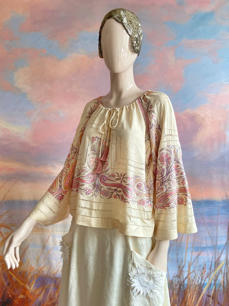 Hand embroidered cream silk blouse with coral and lavender Indian scrolling floral motifs and drawn thread work. A unique piece created from antique textiles by Pavilion Parade