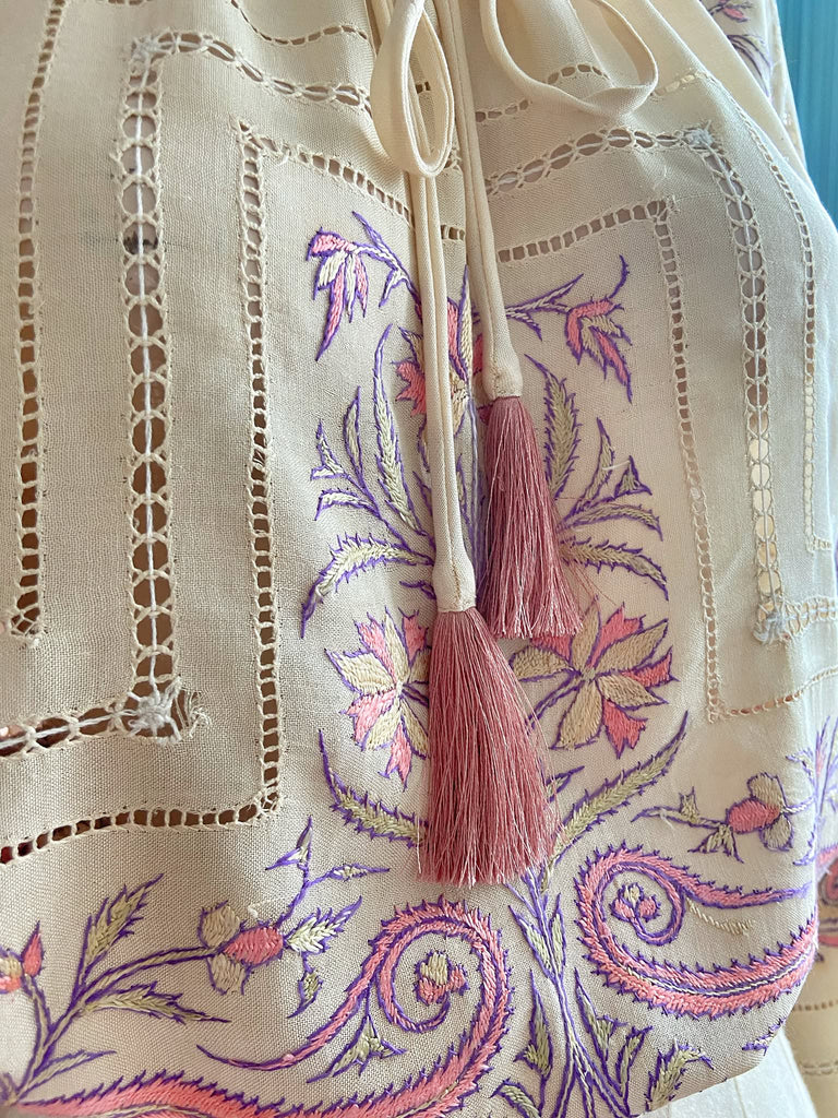 Hand embroidered cream silk blouse with coral and lavender Indian scrolling floral motifs and drawn thread work. A unique piece created from antique textiles by Pavilion Parade