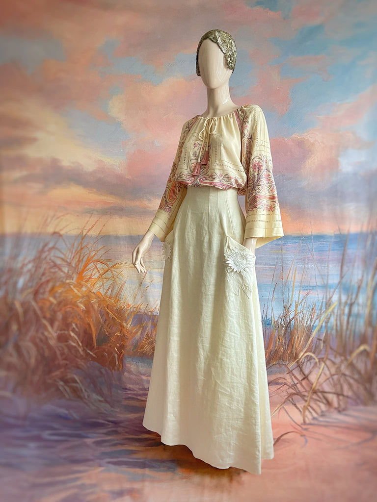 Hand embroidered cream silk blouse with coral and lavender Indian scrolling floral motifs and drawn thread work. A unique piece created from antique textiles by Pavilion Parade