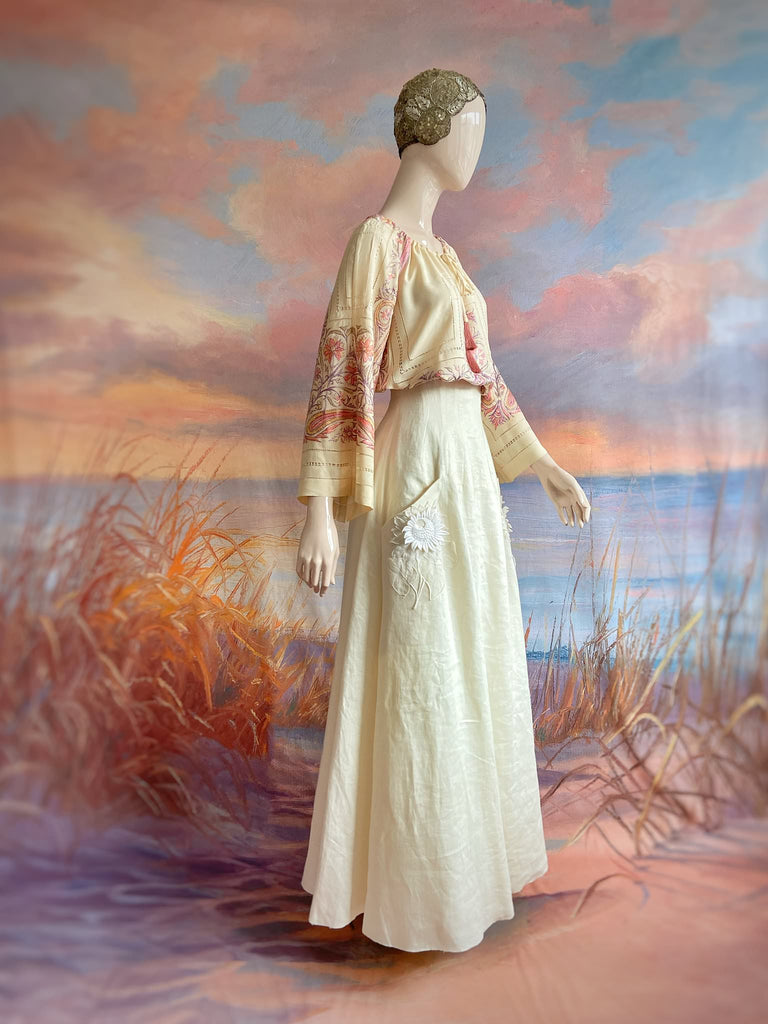 Hand embroidered cream silk blouse with coral and lavender Indian scrolling floral motifs and drawn thread work. A unique piece created from antique textiles by Pavilion Parade