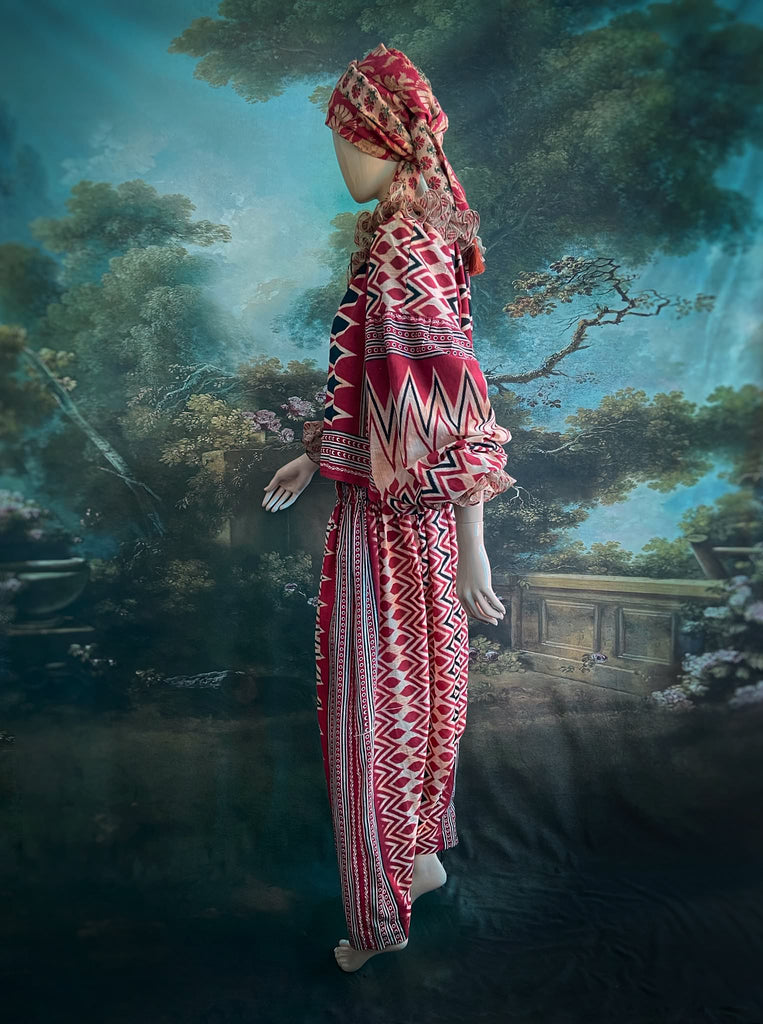 Red, black and ivory fine cotton Harlequin Corsair inspired beach pyjamas with full sleeved frill collar blouse and drawstring Ottoman harem pants. Bohemian styles created from  vintage and antique textiles by the Pavilion Parade studio