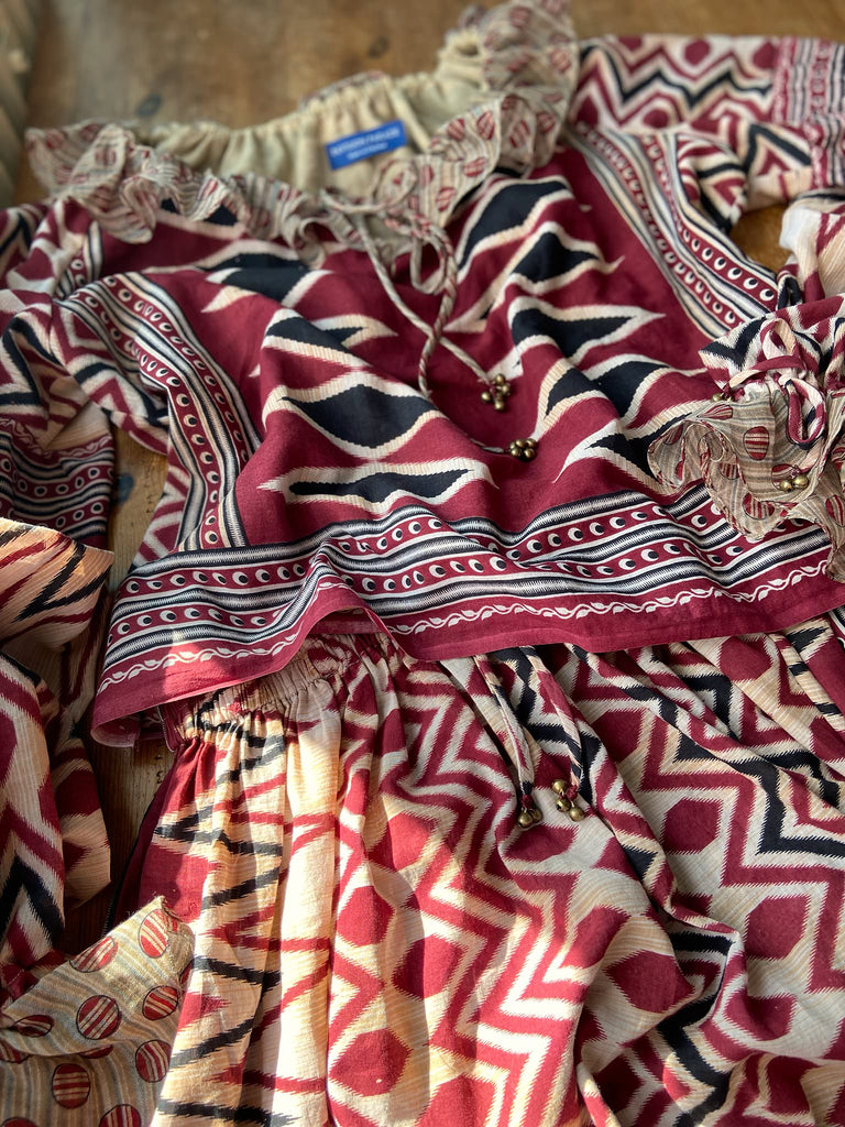 Red, black and ivory fine cotton Harlequin Corsair inspired beach pyjamas with full sleeved frill collar blouse and drawstring Ottoman harem pants. Bohemian styles created from  vintage and antique textiles by the Pavilion Parade studio