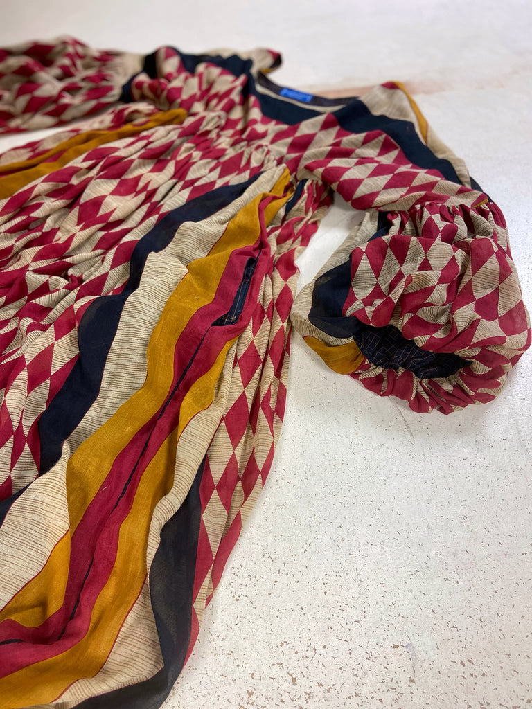 Harlequin red, yellow and black volume dress with long full sleeves and pockets. Bohemian style sustainably created from antique and vintage textiles by the Pavilion Parade studio