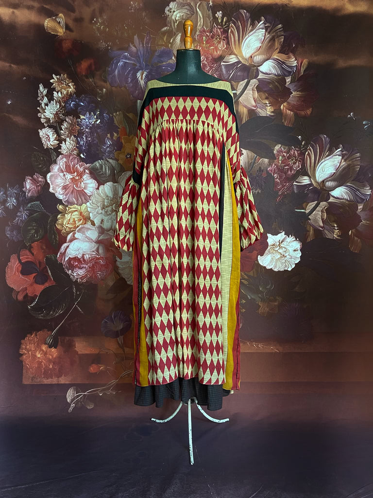 Harlequin red, yellow and black volume dress with long full sleeves and pockets. Bohemian style sustainably created from antique and vintage textiles by the Pavilion Parade studio