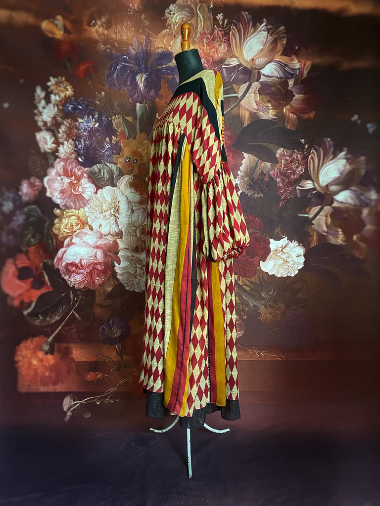Harlequin red, yellow and black volume dress with long full sleeves and pockets. Bohemian style sustainably created from antique and vintage textiles by the Pavilion Parade studio
