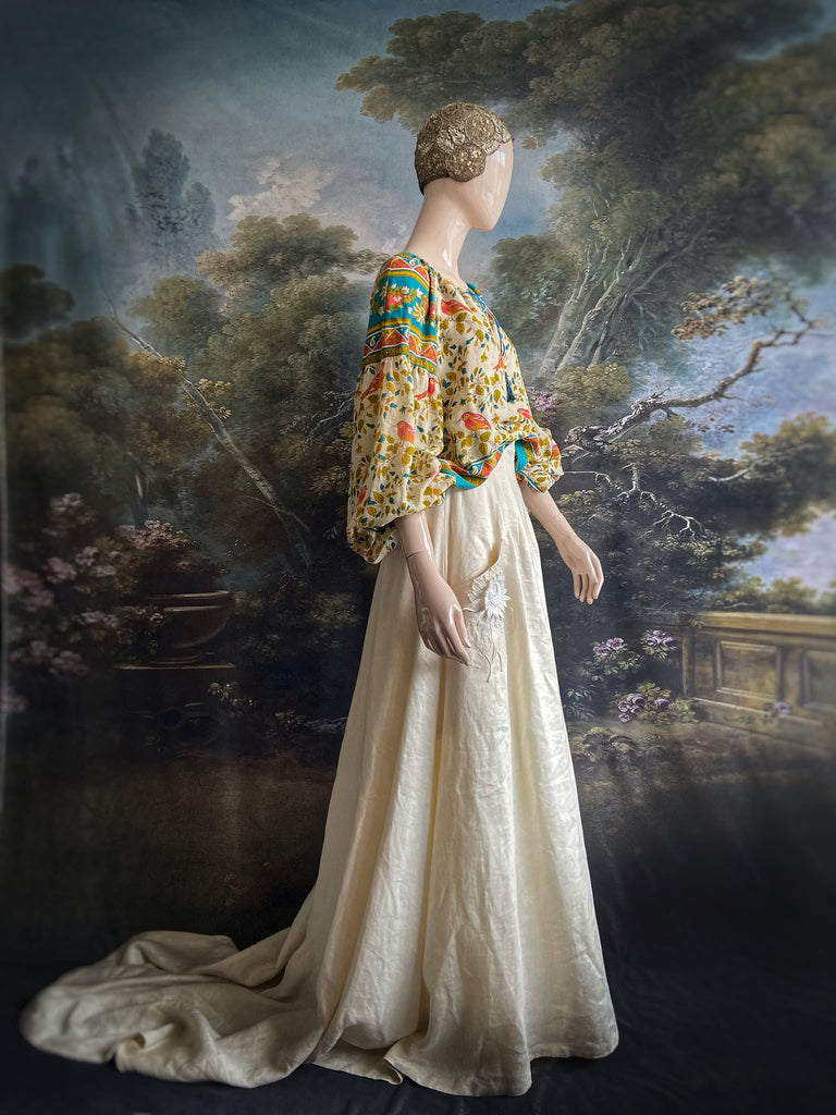 Coral, blue and ivory cotton muslin bird printed blouse with long full sleeves and adjustable drawstring neckline. Bohemian styles sustainably created from antique and vintage textiles by the Pavilion Parade studio. 