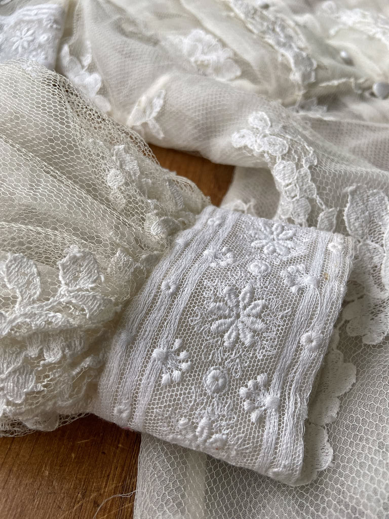 Ivory French lace and silk organza fitted romantic blouse. Antique lace elements at high fitted collar and cuffs. Full bishop sleeves and pleated bodice front. A flight of fancy from the Pavilion Parade studio. 