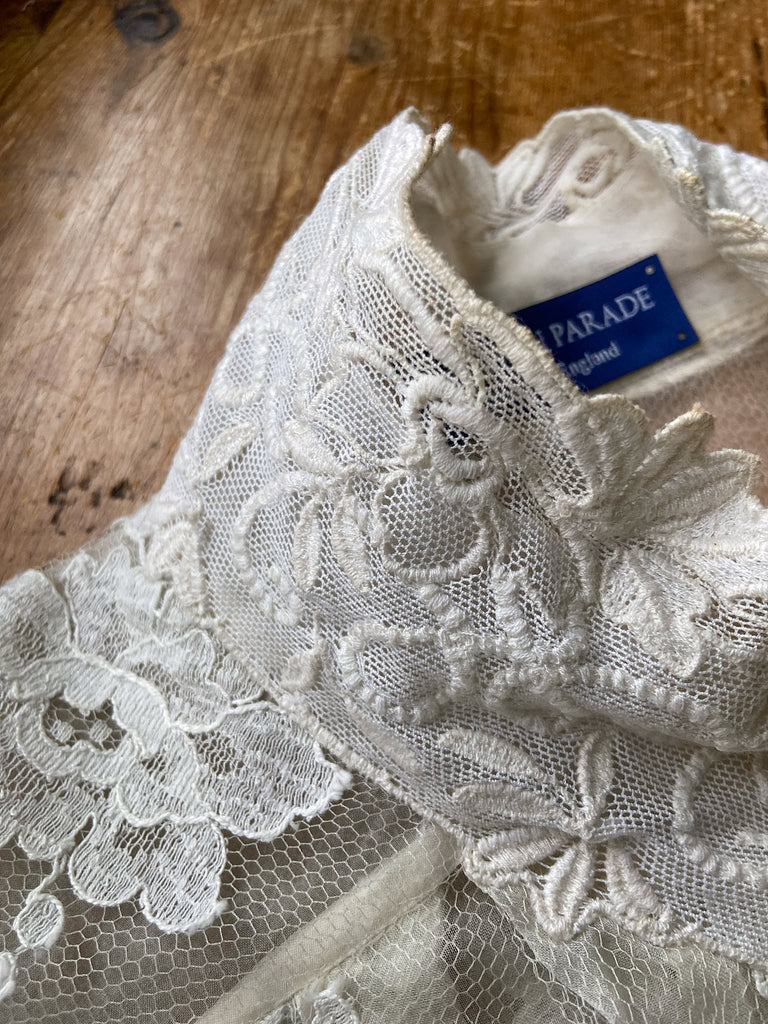 Ivory French lace and silk organza fitted romantic blouse. Antique lace elements at high fitted collar and cuffs. Full bishop sleeves and pleated bodice front. A flight of fancy from the Pavilion Parade studio. 