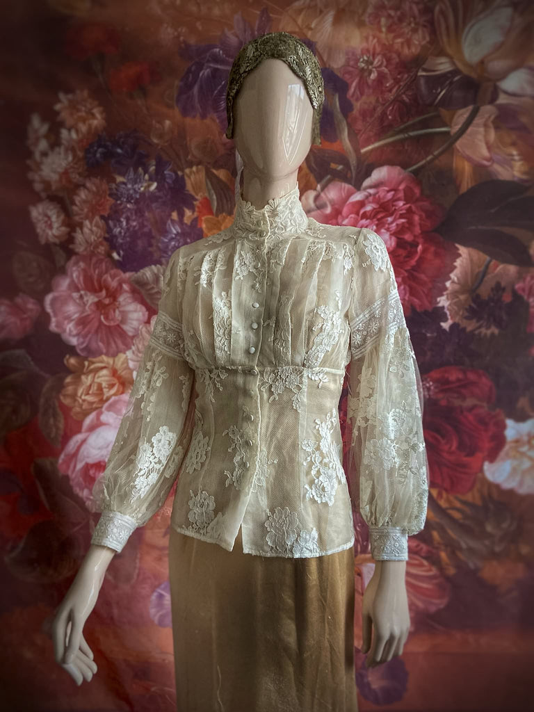 Ivory French lace and silk organza fitted romantic blouse. Antique lace elements at high fitted collar and cuffs. Full bishop sleeves and pleated bodice front. A flight of fancy from the Pavilion Parade studio. 