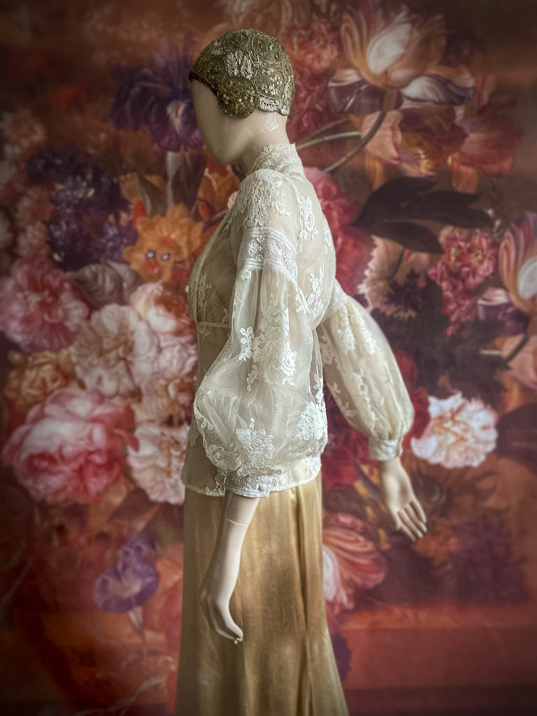 Ivory French lace and silk organza fitted romantic blouse. Antique lace elements at high fitted collar and cuffs. Full bishop sleeves and pleated bodice front. A flight of fancy from the Pavilion Parade studio. 