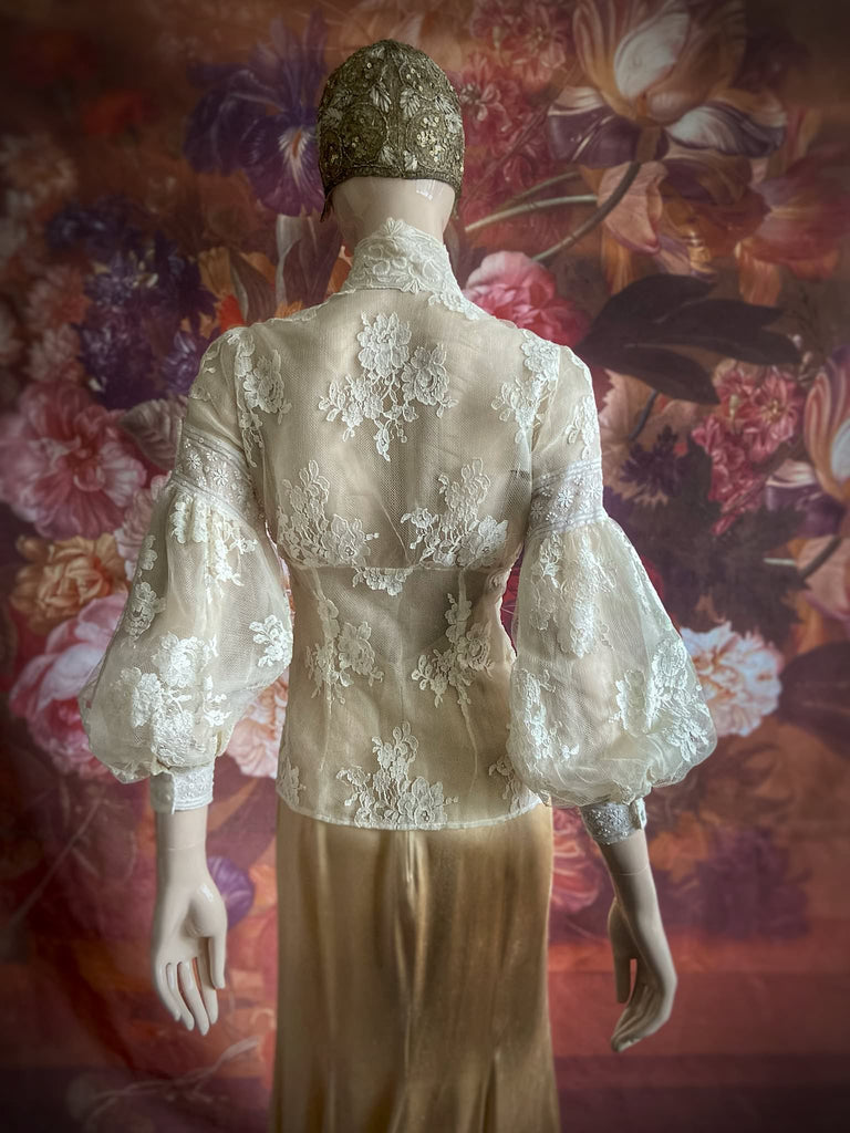 Ivory French lace and silk organza fitted romantic blouse. Antique lace elements at high fitted collar and cuffs. Full bishop sleeves and pleated bodice front. A flight of fancy from the Pavilion Parade studio. 