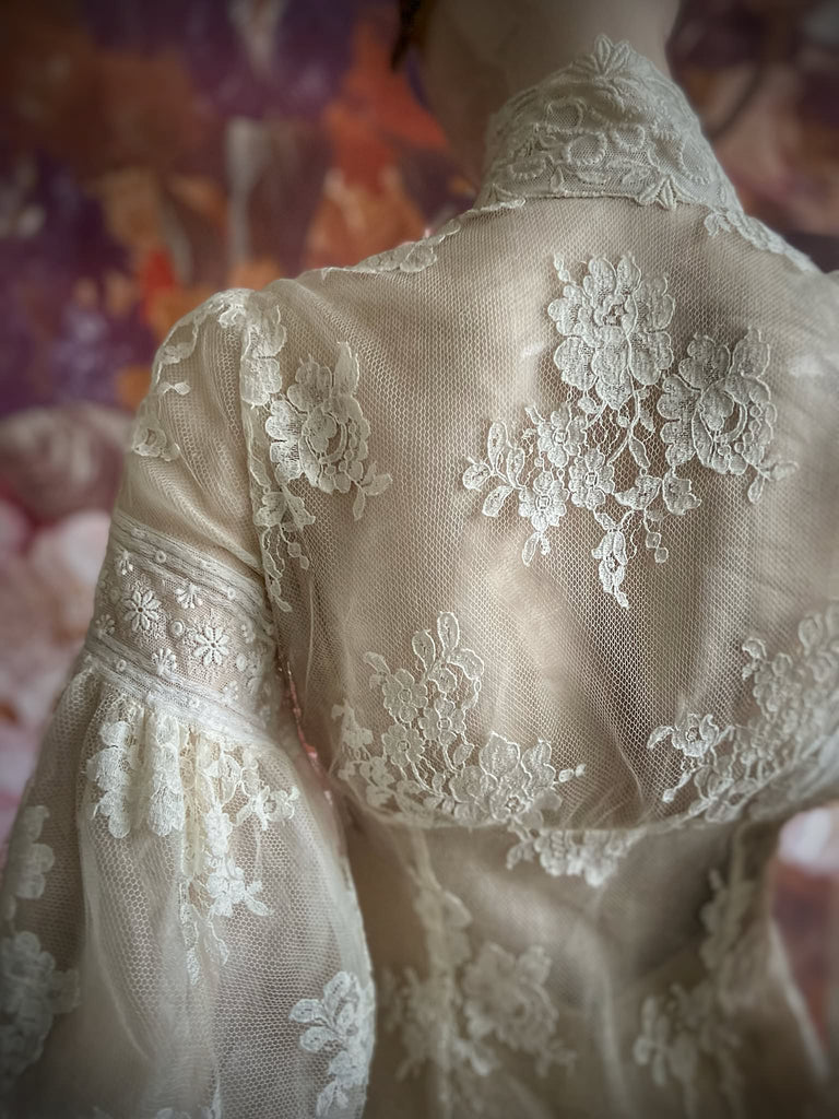 Ivory French lace and silk organza fitted romantic blouse. Antique lace elements at high fitted collar and cuffs. Full bishop sleeves and pleated bodice front. A flight of fancy from the Pavilion Parade studio. 