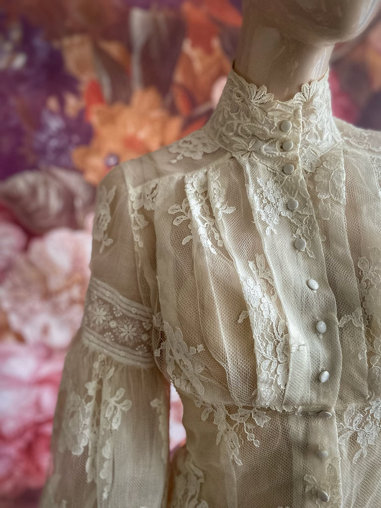 Ivory French lace and silk organza fitted romantic blouse. Antique lace elements at high fitted collar and cuffs. Full bishop sleeves and pleated bodice front. A flight of fancy from the Pavilion Parade studio. 