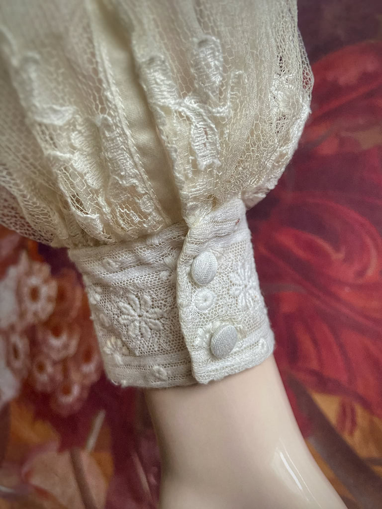 Ivory French lace and silk organza fitted romantic blouse. Antique lace elements at high fitted collar and cuffs. Full bishop sleeves and pleated bodice front. A flight of fancy from the Pavilion Parade studio. 