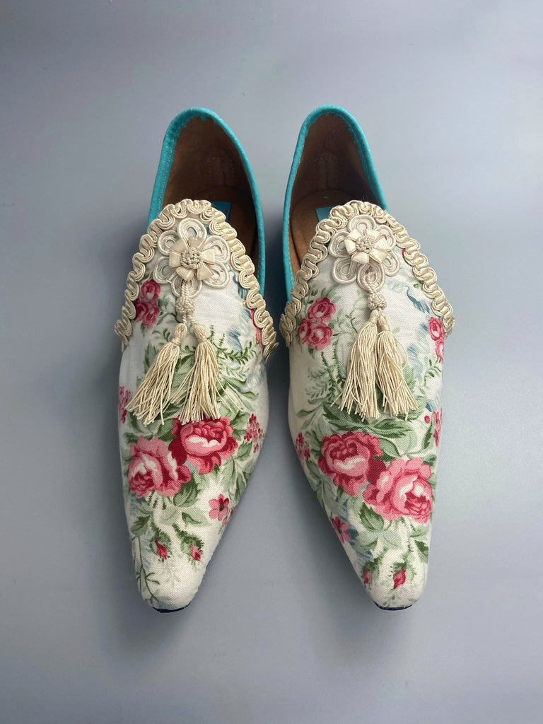 Rosebud toile pointed toe shoes with antique silk tassel appliqué rosettes and passementerie braid. Bohemian style created from antique and vintage textiles by Pavilion Parade.
