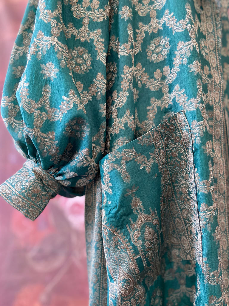 Jade green lightweight silk wrapper robe with full sleeves, large patch pockets and tassel sash. Bohemian style sustainably created from antique and vintage textiles by the Pavilion Parade studio.