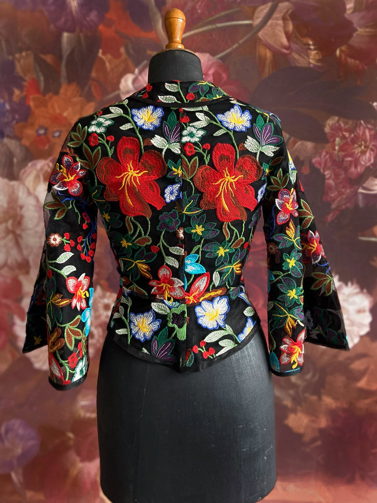 Frida Kahlo inspired embroidered silk and tulle bodice jacket with picture neckline and pagoda sleeves. Vivid black, red, green and blue floral. Flight of fancy from the Pavilion Parade studio. 