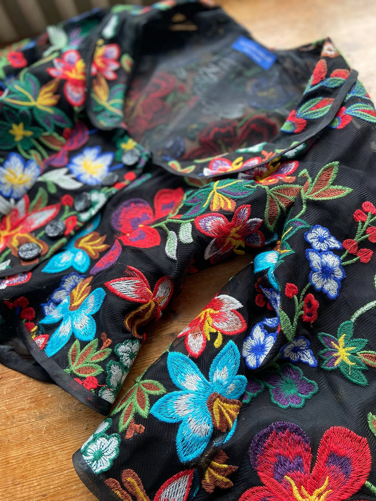 Frida Kahlo inspired embroidered silk and tulle bodice jacket with picture neckline and pagoda sleeves. Vivid black, red, green and blue floral. Flight of fancy from the Pavilion Parade studio. 