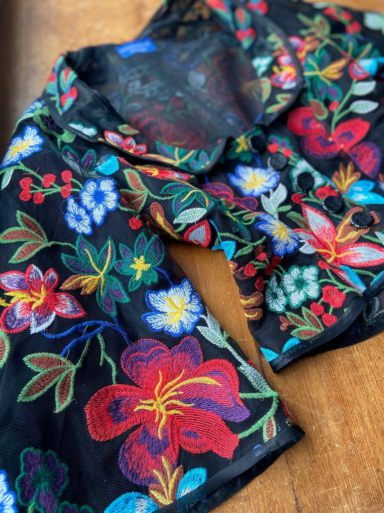 Frida Kahlo inspired embroidered silk and tulle bodice jacket with picture neckline and pagoda sleeves. Vivid black, red, green and blue floral. Flight of fancy from the Pavilion Parade studio. 