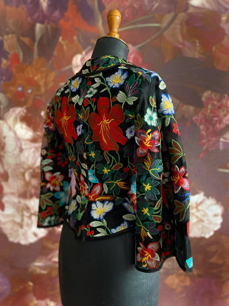 Frida Kahlo inspired embroidered silk and tulle bodice jacket with picture neckline and pagoda sleeves. Vivid black, red, green and blue floral. Flight of fancy from the Pavilion Parade studio. 