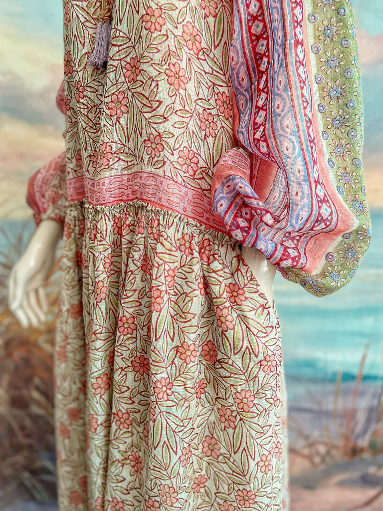 Summer floral apricot and lavender fine handwoven cotton block printed dress with long full sleeves and adjustable drawstring neckline. Bohemian styles sustainably created from antique and vintage textiles by the Pavilion Parade studio. 
