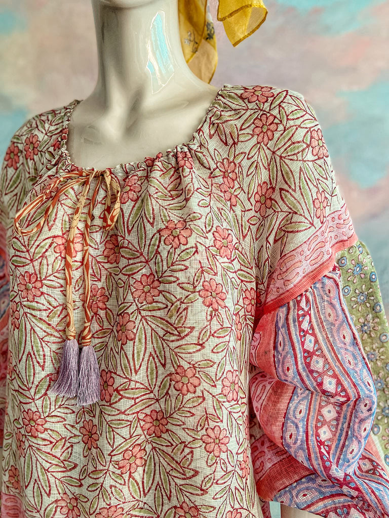 Summer floral apricot and lavender fine handwoven cotton block printed dress with long full sleeves and adjustable drawstring neckline. Bohemian styles sustainably created from antique and vintage textiles by the Pavilion Parade studio. 