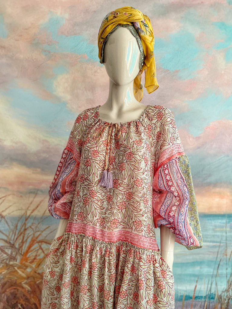 Summer floral apricot and lavender fine handwoven cotton block printed dress with long full sleeves and adjustable drawstring neckline. Bohemian styles sustainably created from antique and vintage textiles by the Pavilion Parade studio. 