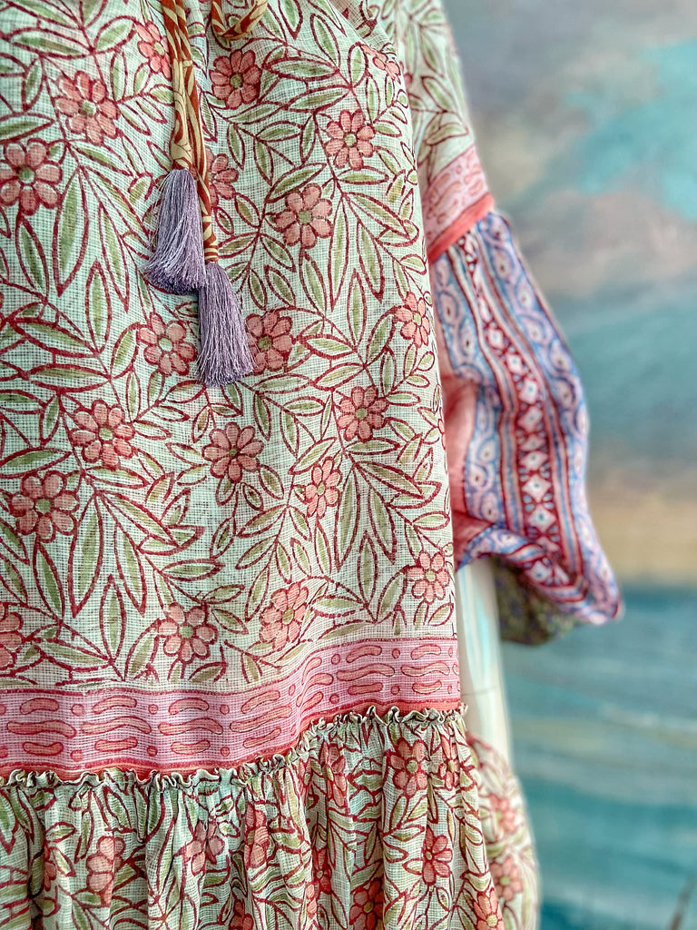 Summer floral apricot and lavender fine handwoven cotton block printed dress with long full sleeves and adjustable drawstring neckline. Bohemian styles sustainably created from antique and vintage textiles by the Pavilion Parade studio. 