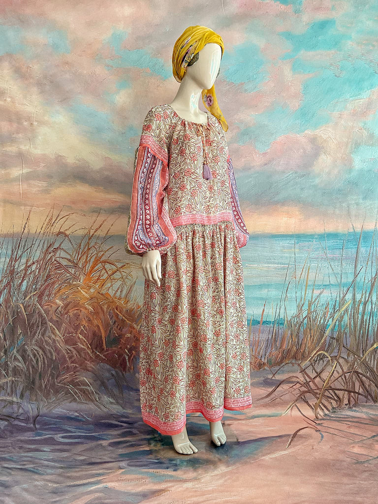Summer floral apricot and lavender fine handwoven cotton block printed dress with long full sleeves and adjustable drawstring neckline. Bohemian styles sustainably created from antique and vintage textiles by the Pavilion Parade studio. 