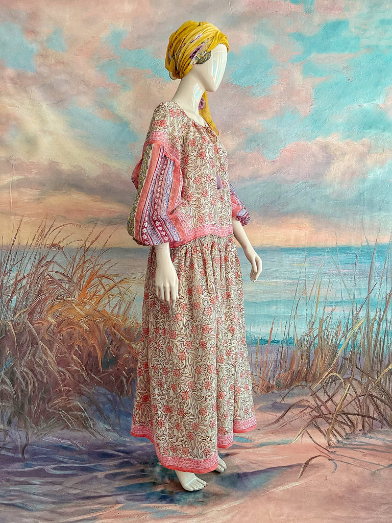 Summer floral apricot and lavender fine handwoven cotton block printed dress with long full sleeves and adjustable drawstring neckline. Bohemian styles sustainably created from antique and vintage textiles by the Pavilion Parade studio. 