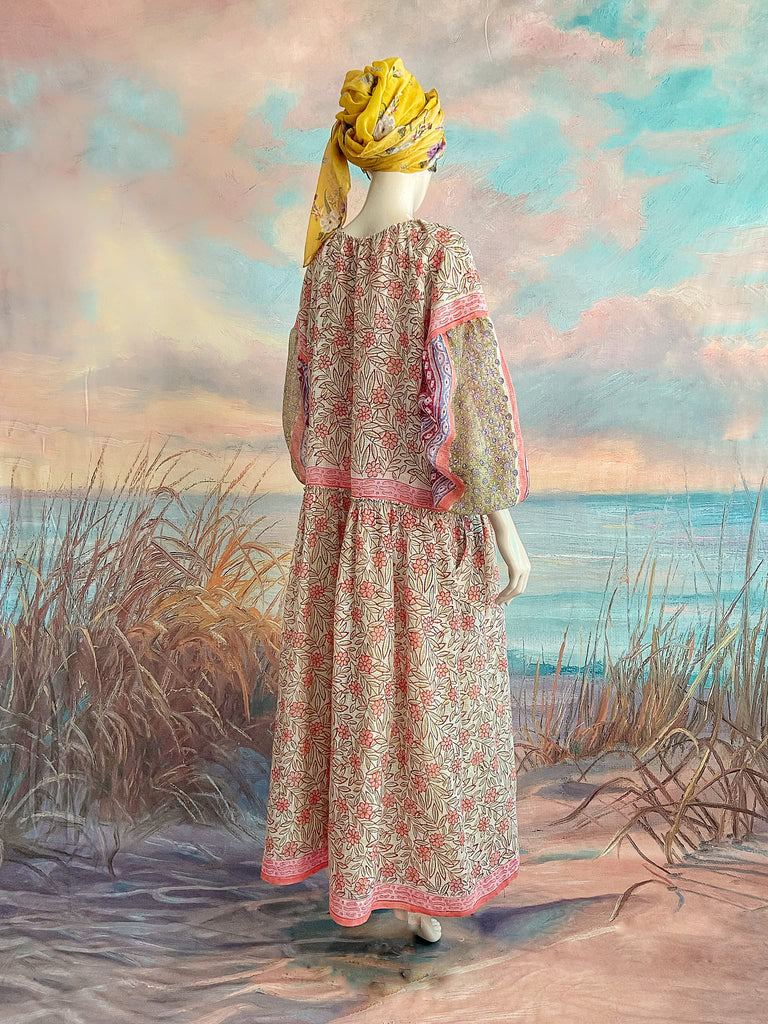 Summer floral apricot and lavender fine handwoven cotton block printed dress with long full sleeves and adjustable drawstring neckline. Bohemian styles sustainably created from antique and vintage textiles by the Pavilion Parade studio. 