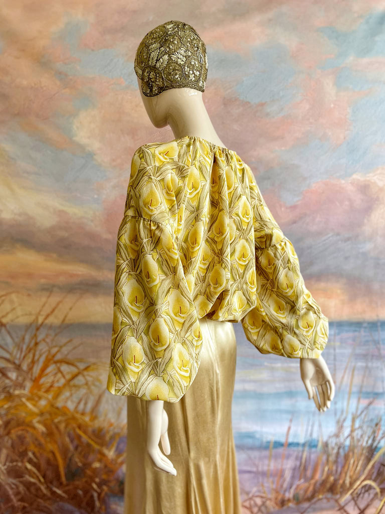 Lemon yellow and sage green silk crepe Calla lily printed blouse with long full sleeves and adjustable drawstring neckline. Bohemian styles sustainably created from antique and vintage textiles by the Pavilion Parade studio. 