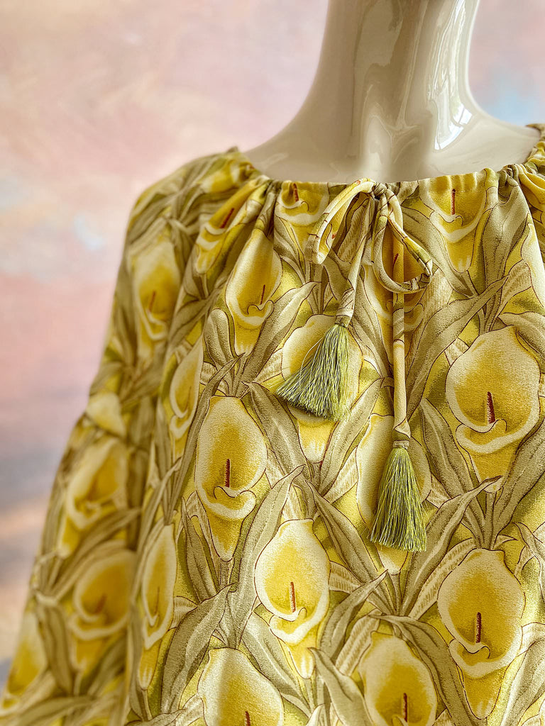 Lemon yellow and sage green silk crepe Calla lily printed blouse with long full sleeves and adjustable drawstring neckline. Bohemian styles sustainably created from antique and vintage textiles by the Pavilion Parade studio. 