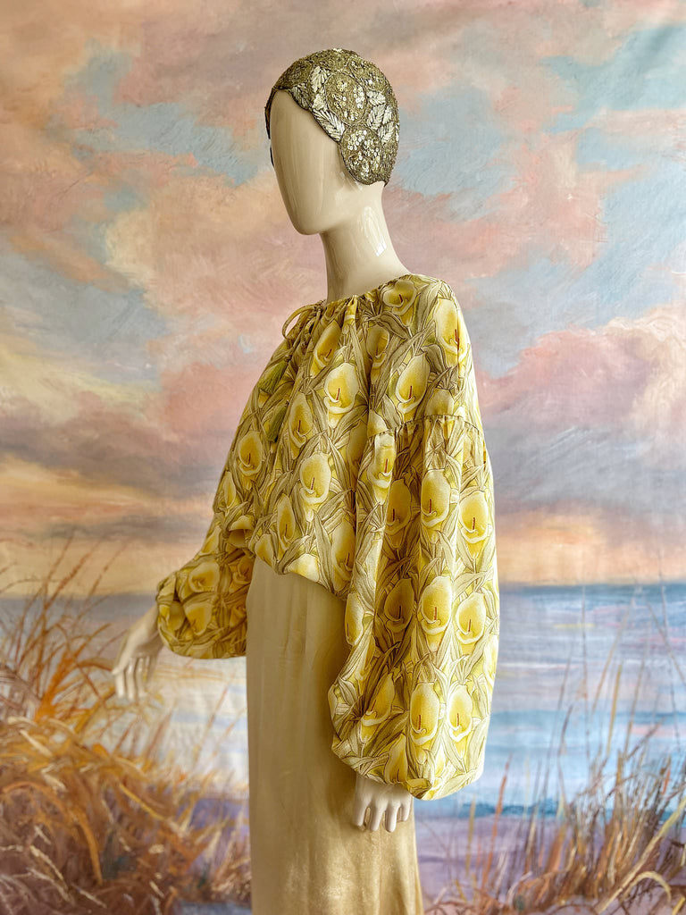 Lemon yellow and sage green silk crepe Calla lily printed blouse with long full sleeves and adjustable drawstring neckline. Bohemian styles sustainably created from antique and vintage textiles by the Pavilion Parade studio. 